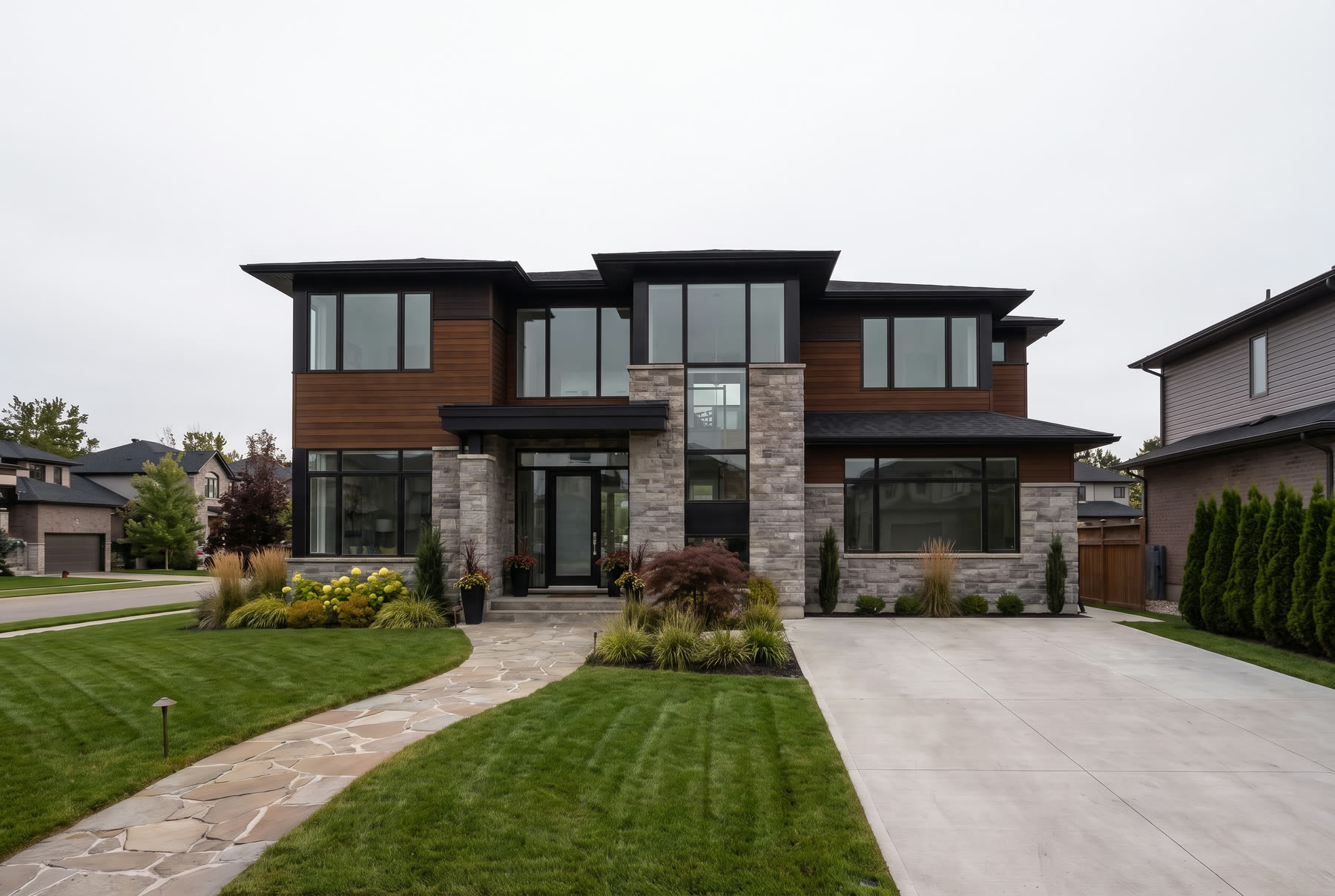 The same house as a flat midday phone photo under overcast cloud.
